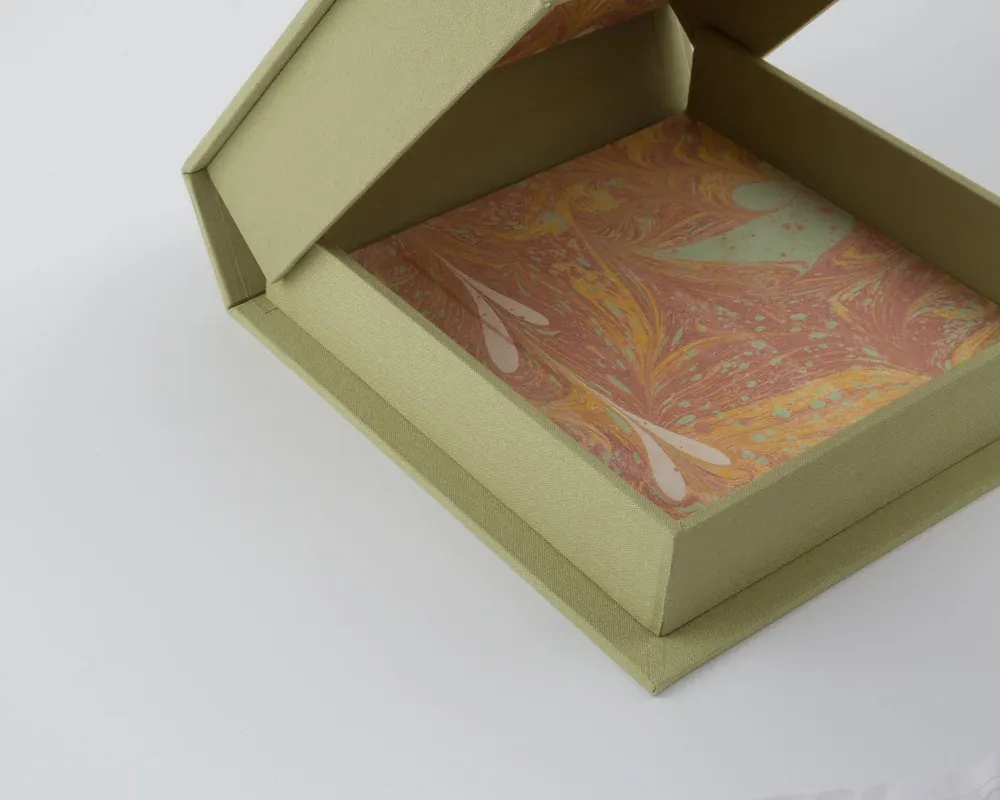 A box with a marbled interior, lined and empty