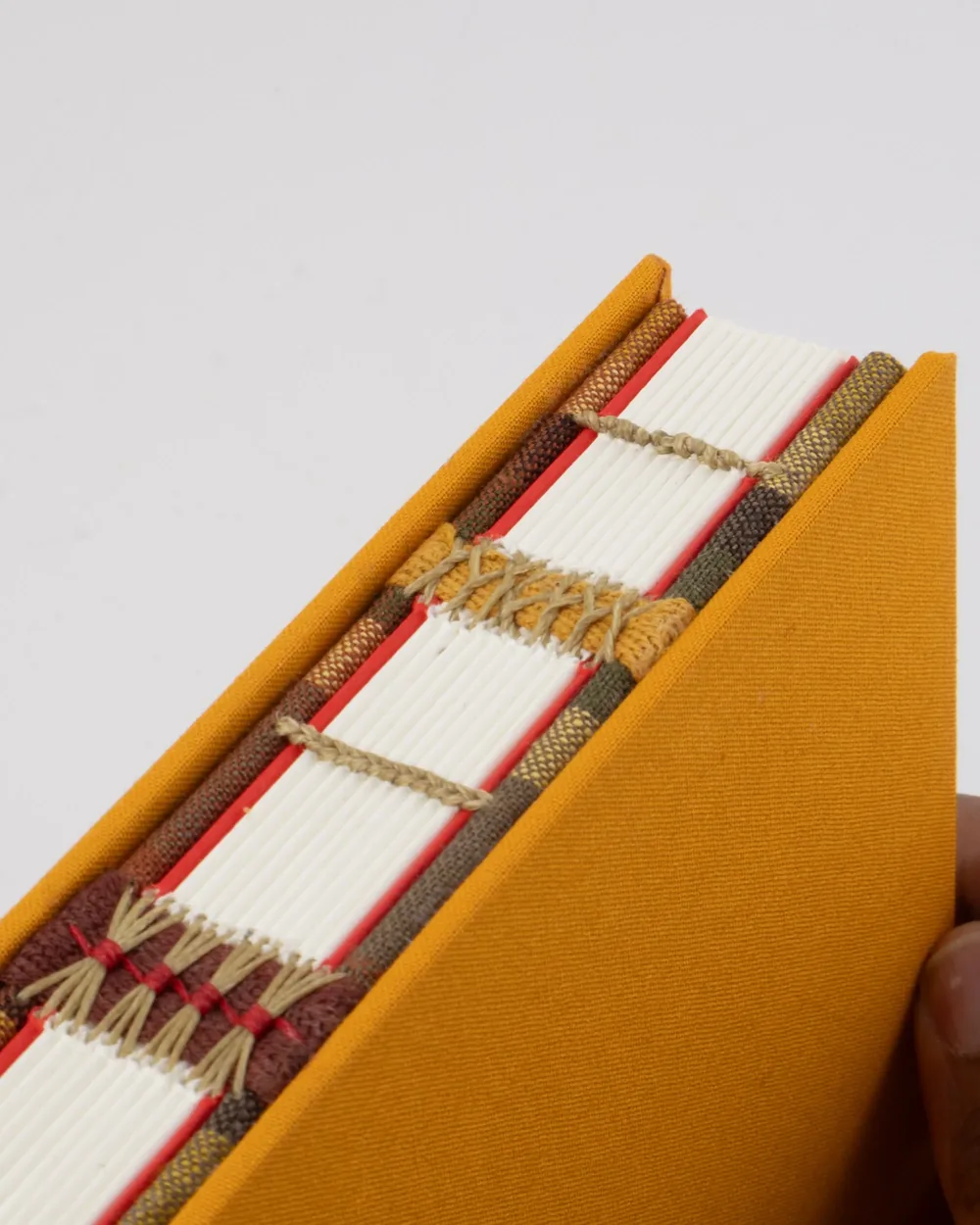 Close-up of a book with a yellow cover and stick-on tabs marking several pages.
