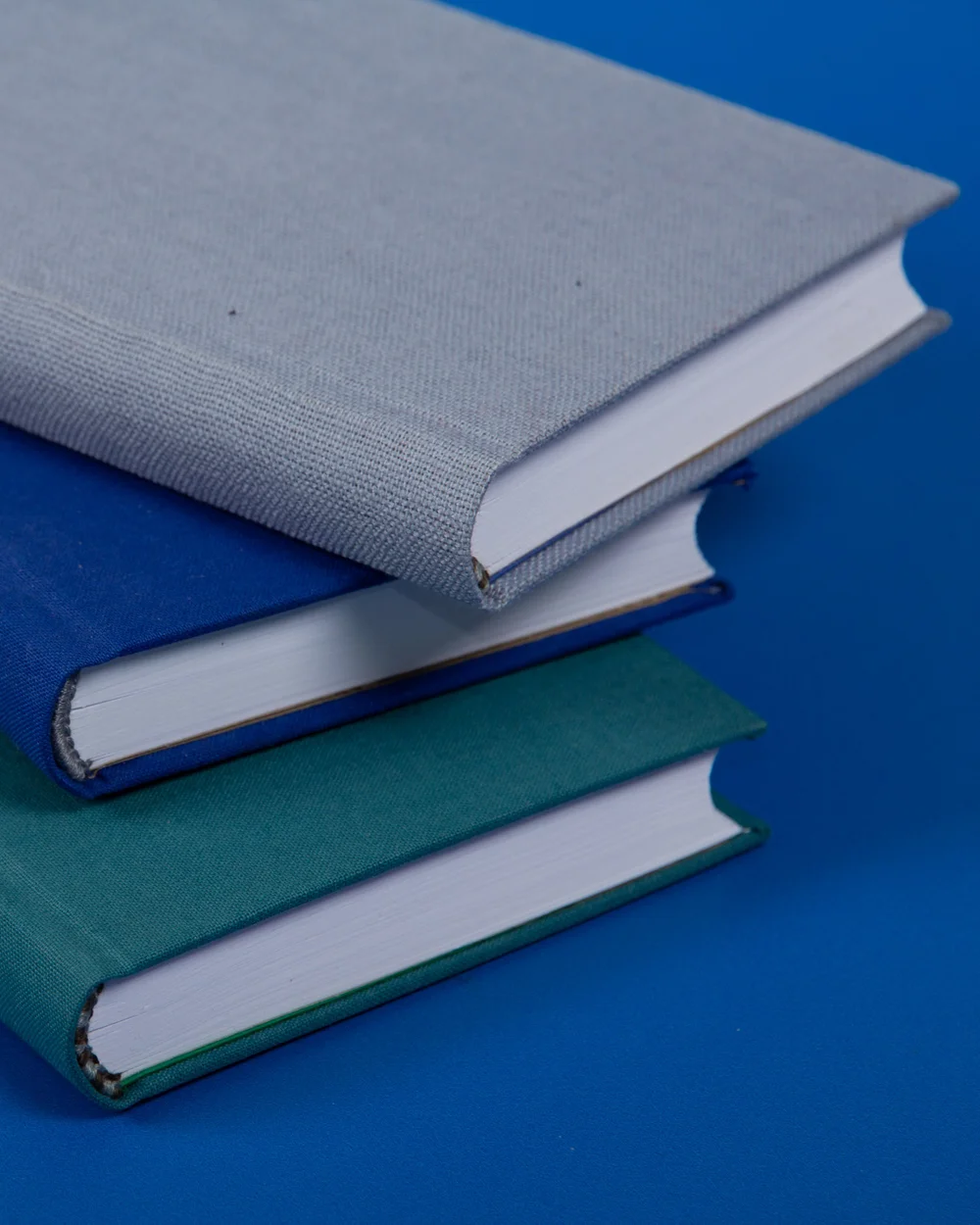 Hands shaping the curved spine of a Bradel binding