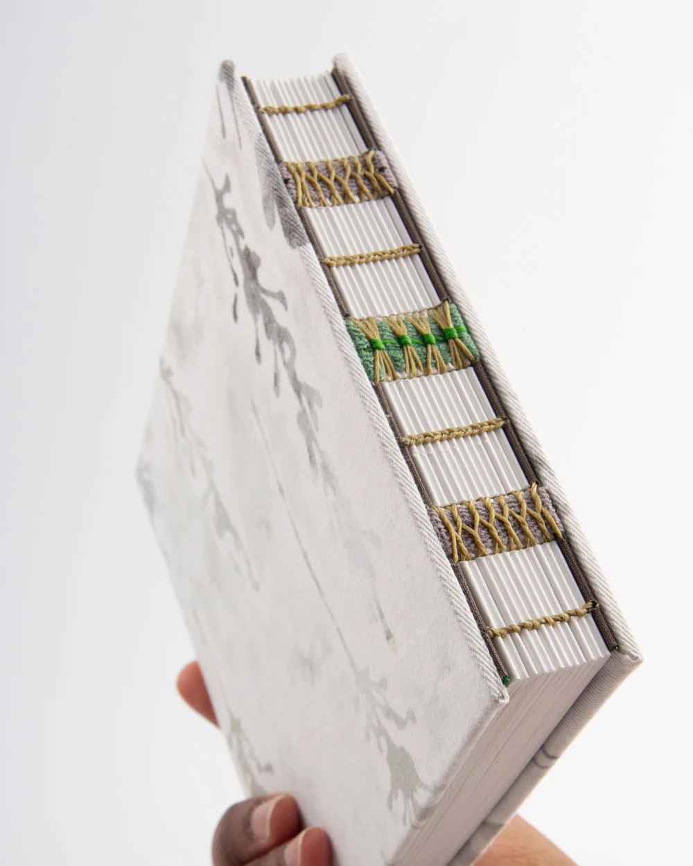 A finished exposed-spine binding showing the sewn spine and bands