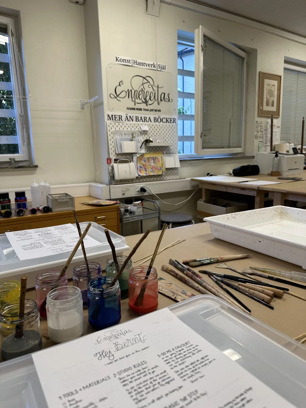 Marbling inks and brushes laid out ready to use in the studio