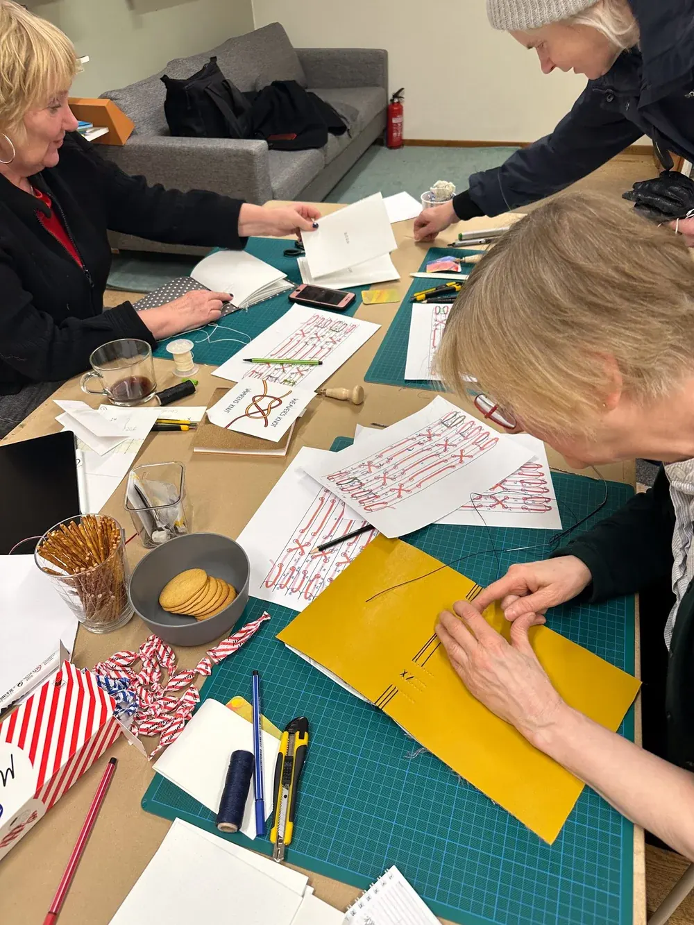 A group working on a crafting project together at a table
